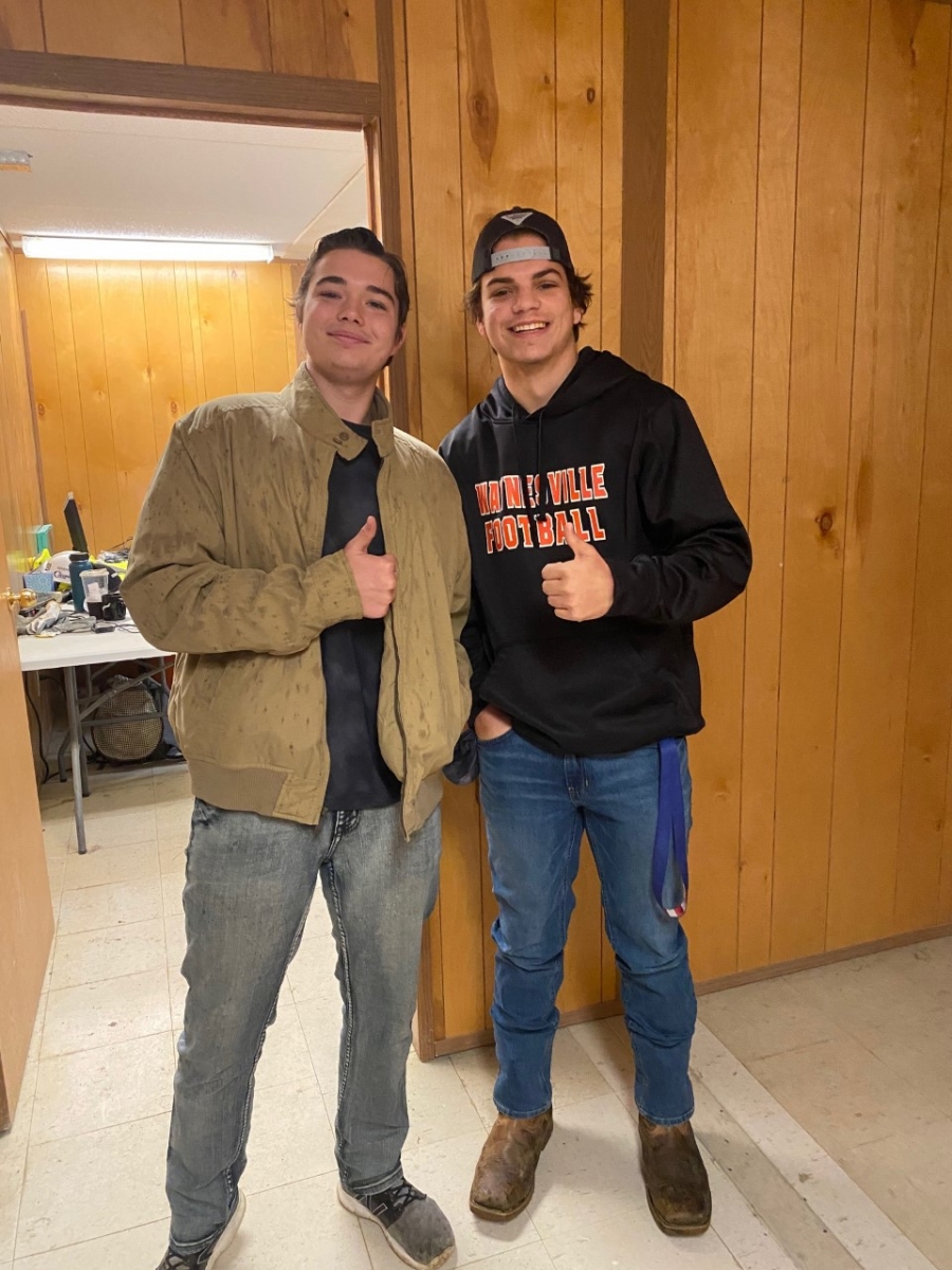 two young men smiling in a doorway